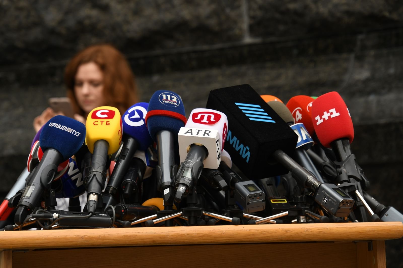 Microphones on a desk at a press conference